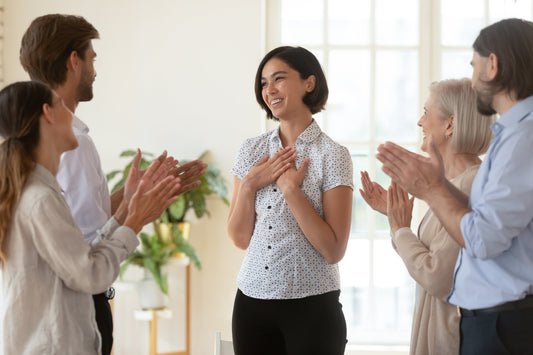 Team of coworkers showing appreciation to an employee