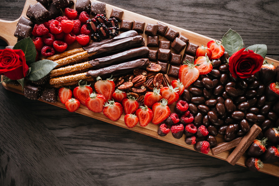 Decadent dessert charcuterie board featuring chocolate treats and fruit 