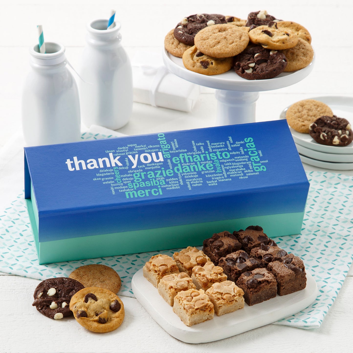 Appreciation gift box surrounded by an assortment of nibblers and brownie bites