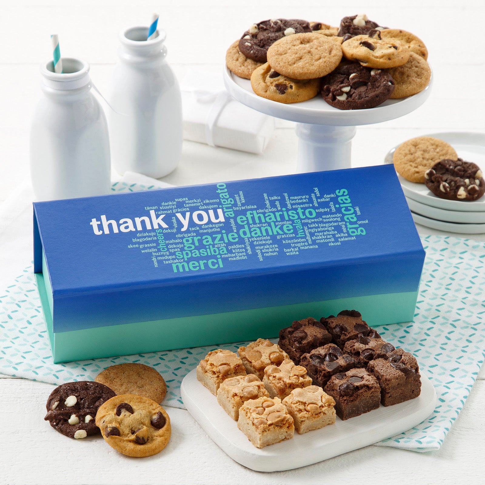 Appreciation gift box surrounded by an assortment of nibblers and brownie bites