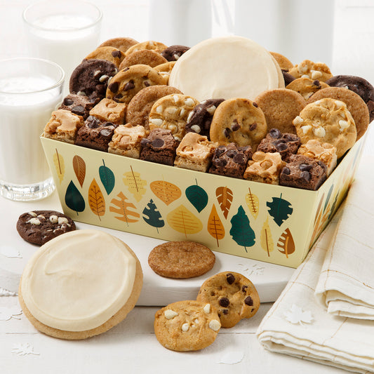 Yellow fall themed crate with fall leaves. This crate is filled with an assortment of Nibblers®, brownie bites and frosted cookies.