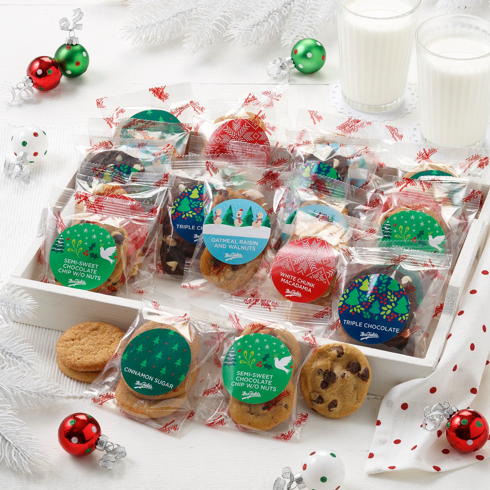 An assortment of packaged Nibblers® that each flavor has a festive holiday sticker