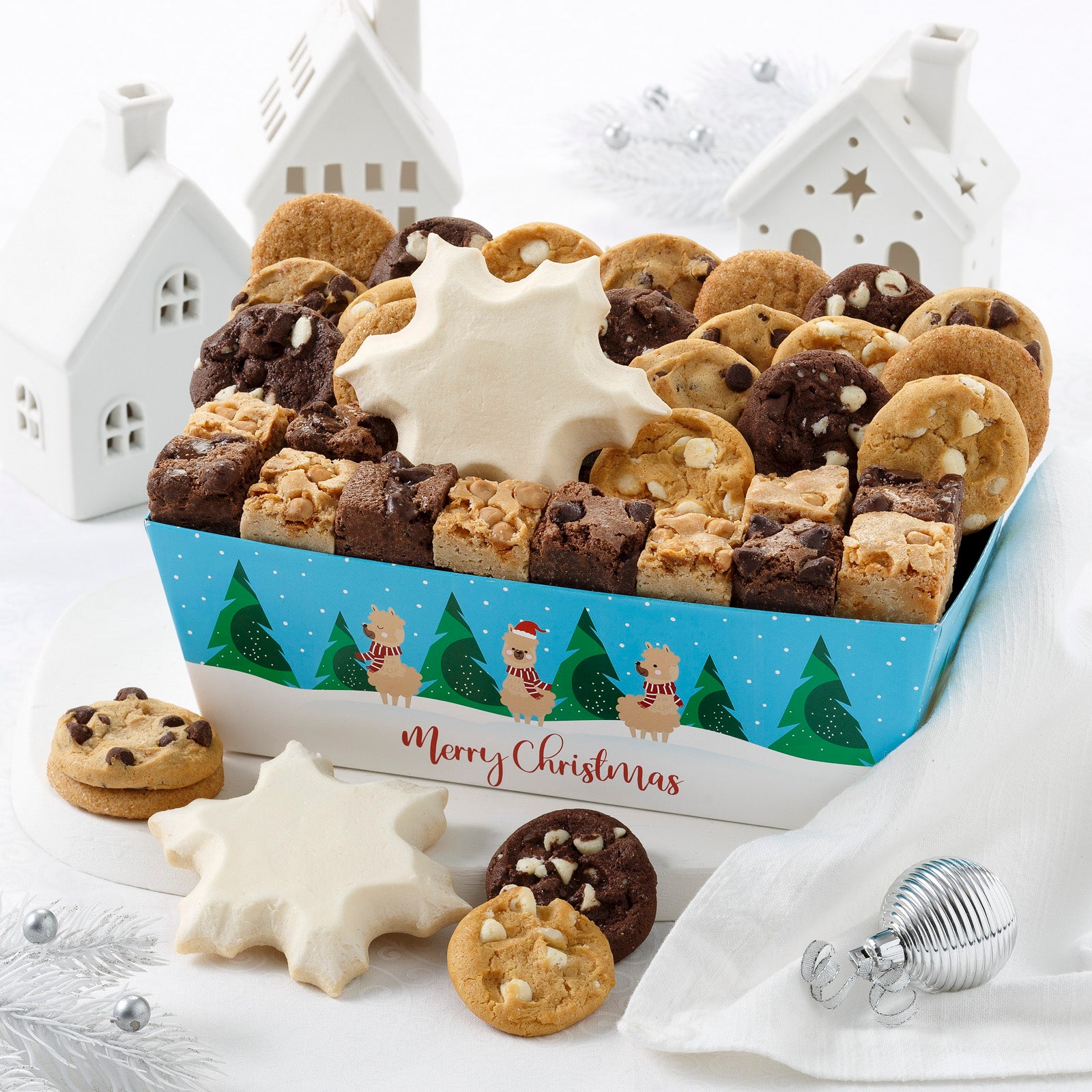 Christmas crate decorated with a winter scene and three festive llamas and filled with an assortment of Nibblers®, brownie bites and two snowflake cookies