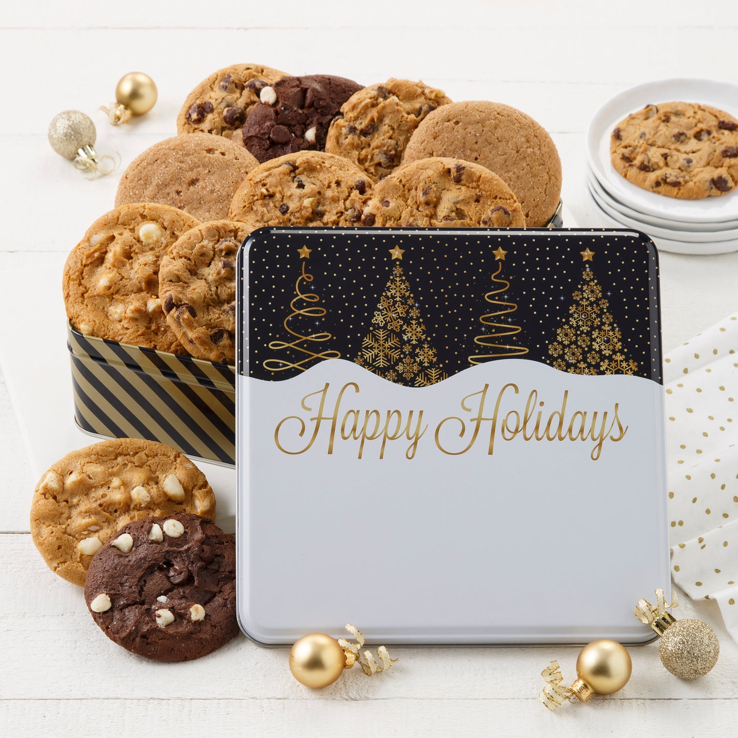 A Happy Holidays black and gold tin decorated with Christmas trees and filled with an assortment of original cookies.