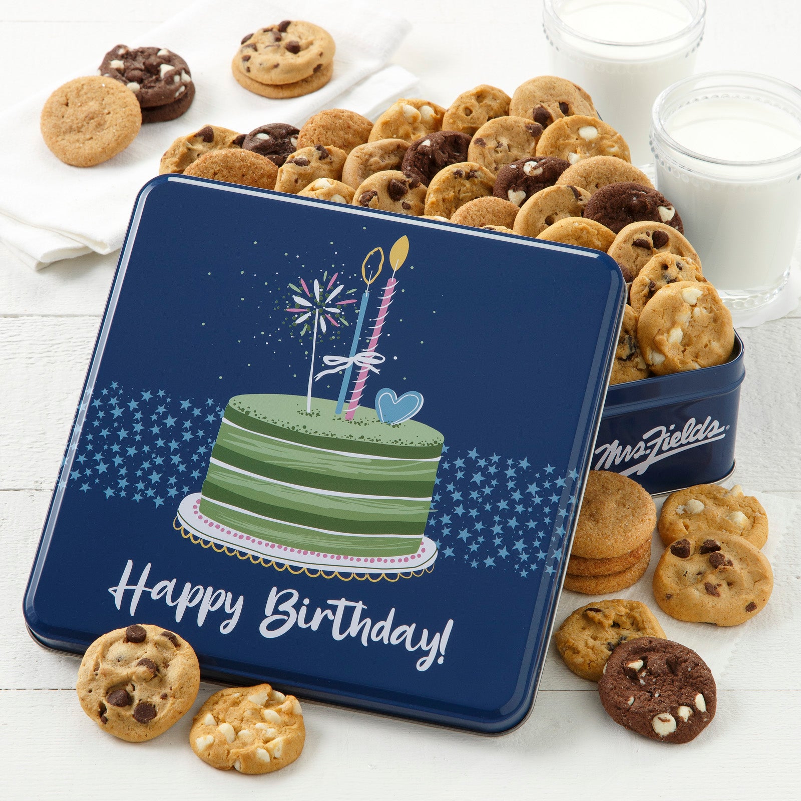 A blue Happy Birthday tin with a green Birthday cake on the front. The tin is filled with Nibblers® bite-sized cookies