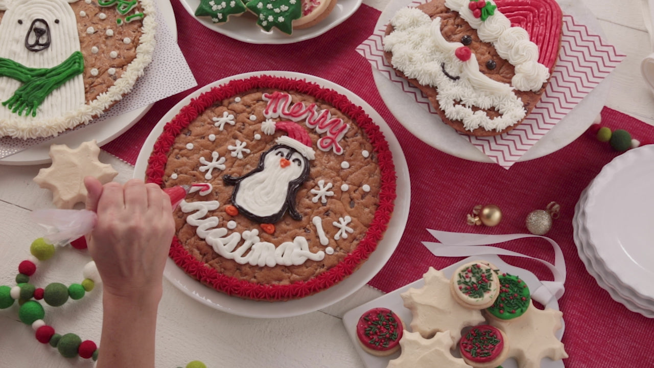 A video of decorating holiday themed cookies and cookies cakes