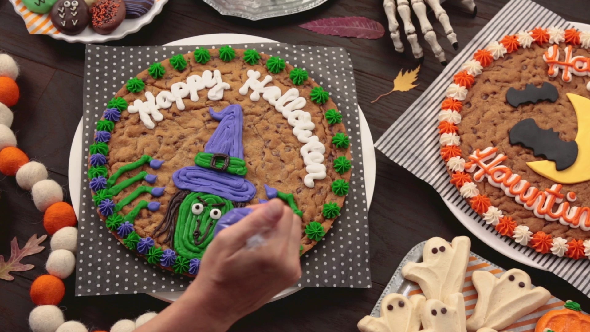 A video that shows decorating the different halloween cookies cakes and halloween frosted cookies